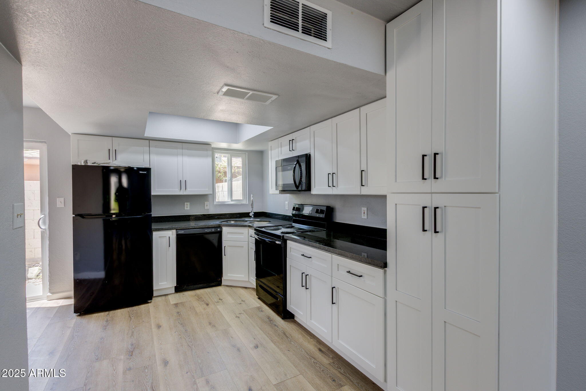 3048 East Beck Lane Phoenix, AZ 85032 - Photo 7 of 13 a kitchen with granite countertop a refrigerator stove top oven and sink