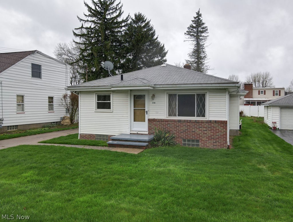 770 Yerrick Road Akron, OH 44312 - Photo 28 of 28 View of front facade with a garage and a front lawn