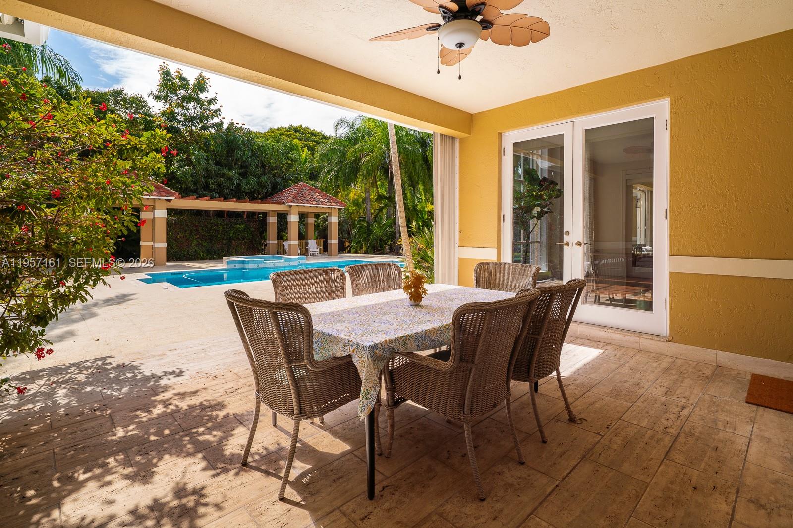 5770 Southwest 128th Street Pinecrest, FL 33156 - Photo 9 of 37 a view of a dining table and chairs in the patio