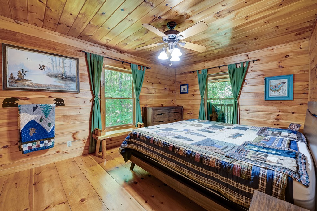 30 The Forest Road Blue Ridge, GA 30513 - Photo 19 of 47 a bedroom with a bed dresser and a large window