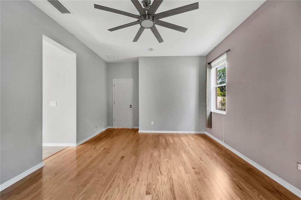 10229 Avelar Ridge Drive Riverview, FL 33578 - Photo 17 of 39 a view of a big room with wooden floor and windows in a room