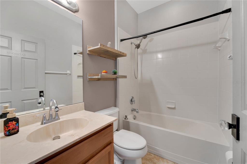 10229 Avelar Ridge Drive Riverview, FL 33578 - Photo 22 of 39 a bathroom with a sink toilet and shower