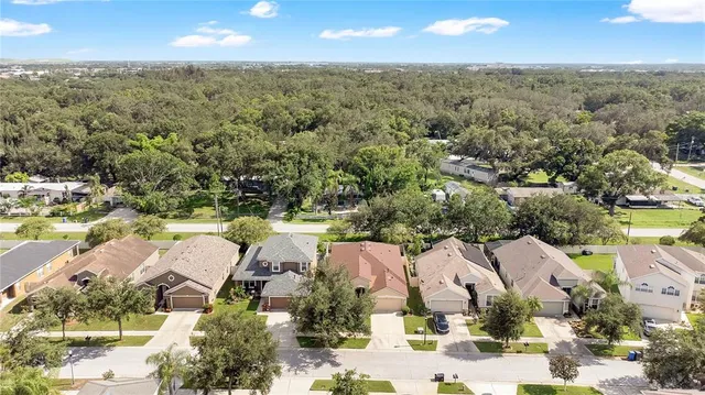an aerial view of residential houses with outdoor space and street view