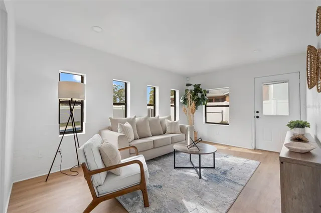a living room with furniture and wooden floor