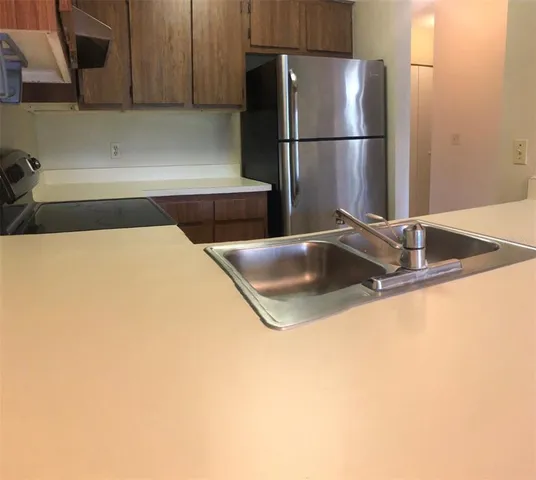 a kitchen with a refrigerator and a sink