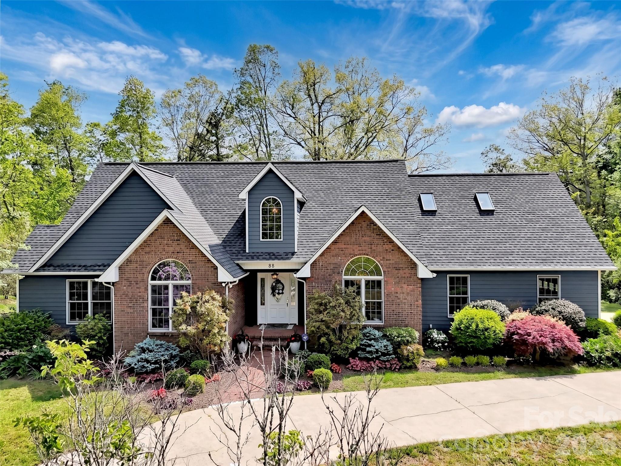 88 Adams Drive Clyde, NC 28721 - Photo 1 of 47 a front view of a house with garden