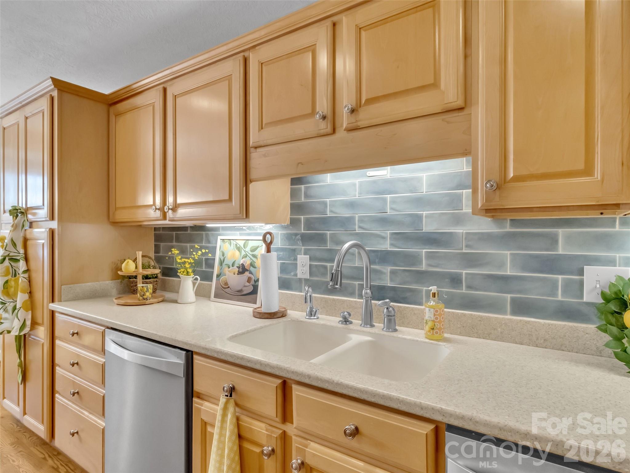 88 Adams Drive Clyde, NC 28721 - Photo 11 of 47 a kitchen with stainless steel appliances granite countertop a sink and cabinets