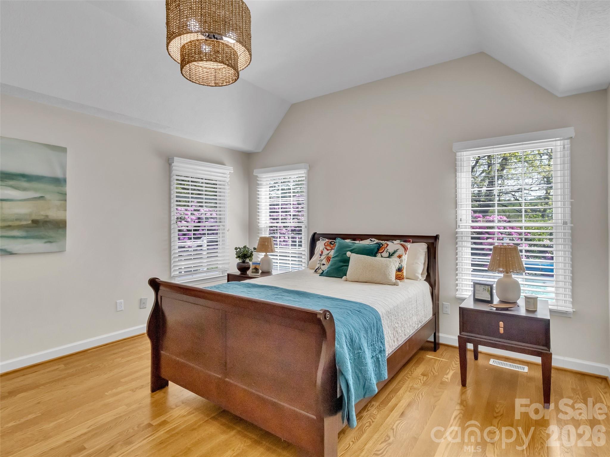 88 Adams Drive Clyde, NC 28721 - Photo 14 of 47 a bedroom with a bed and a chandelier