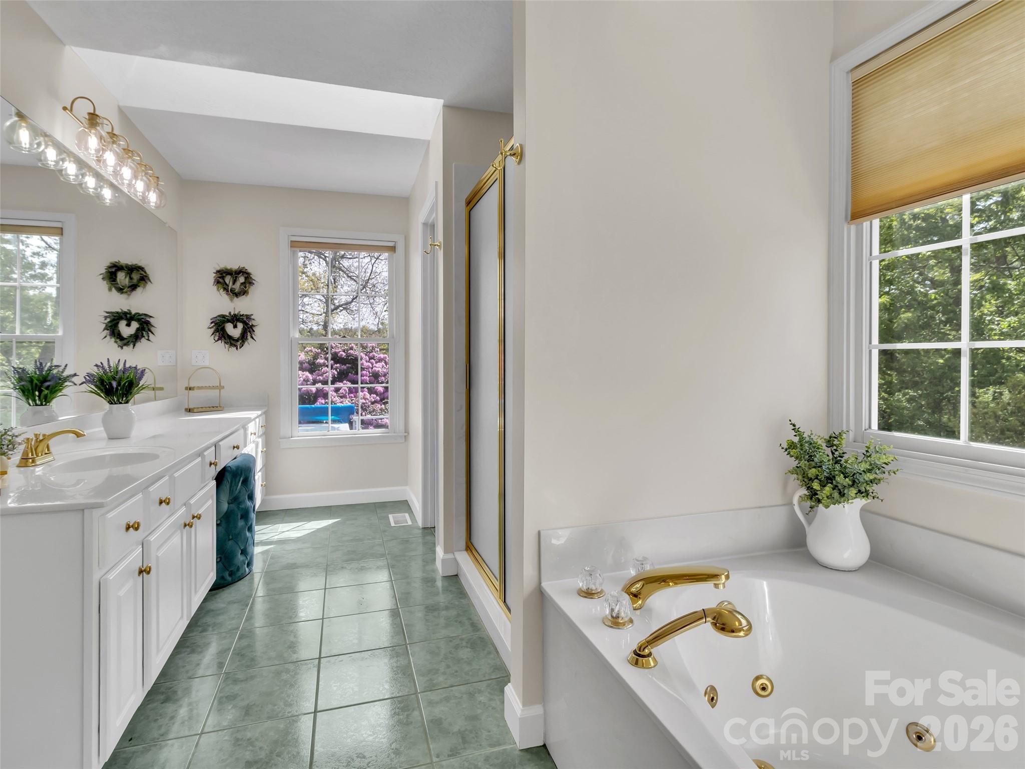 88 Adams Drive Clyde, NC 28721 - Photo 15 of 47 a bathroom with a tub sink and mirror