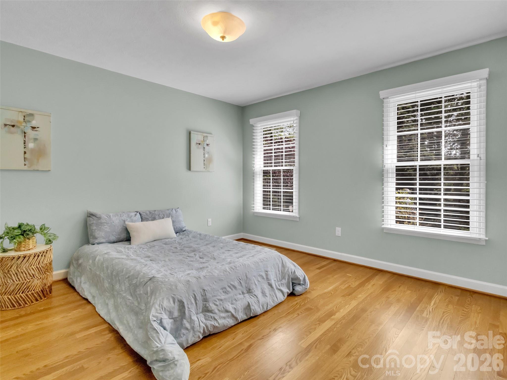 88 Adams Drive Clyde, NC 28721 - Photo 24 of 47 a bedroom with a bed and wooden floor