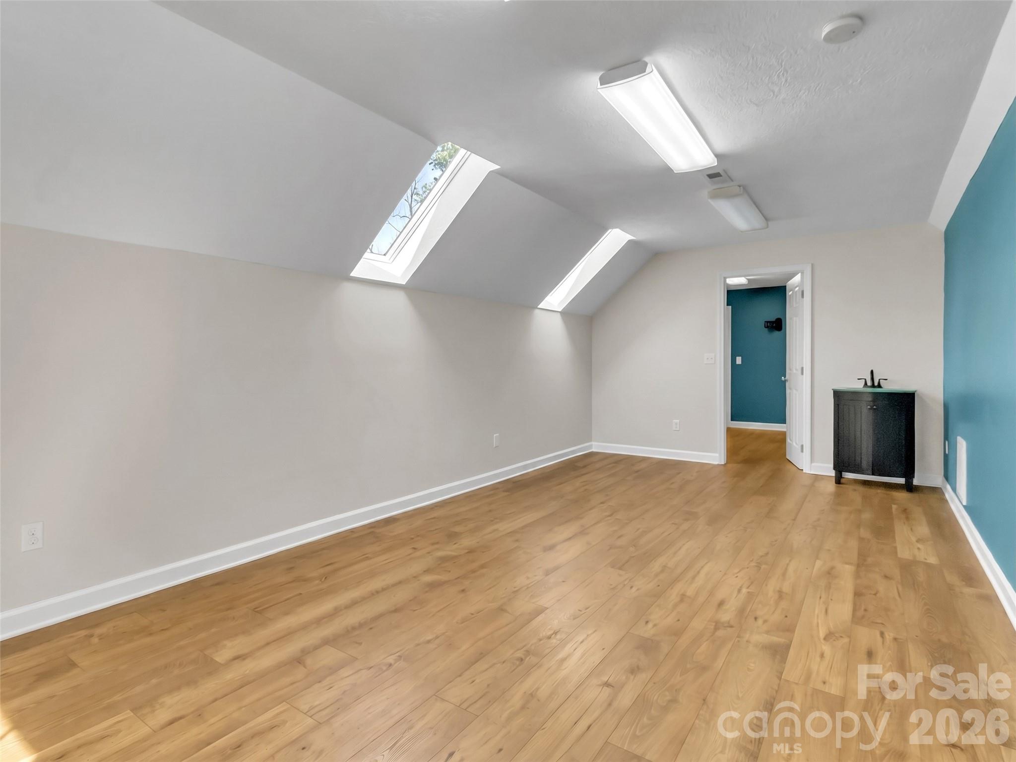 88 Adams Drive Clyde, NC 28721 - Photo 25 of 47 a view of empty room with wooden floor