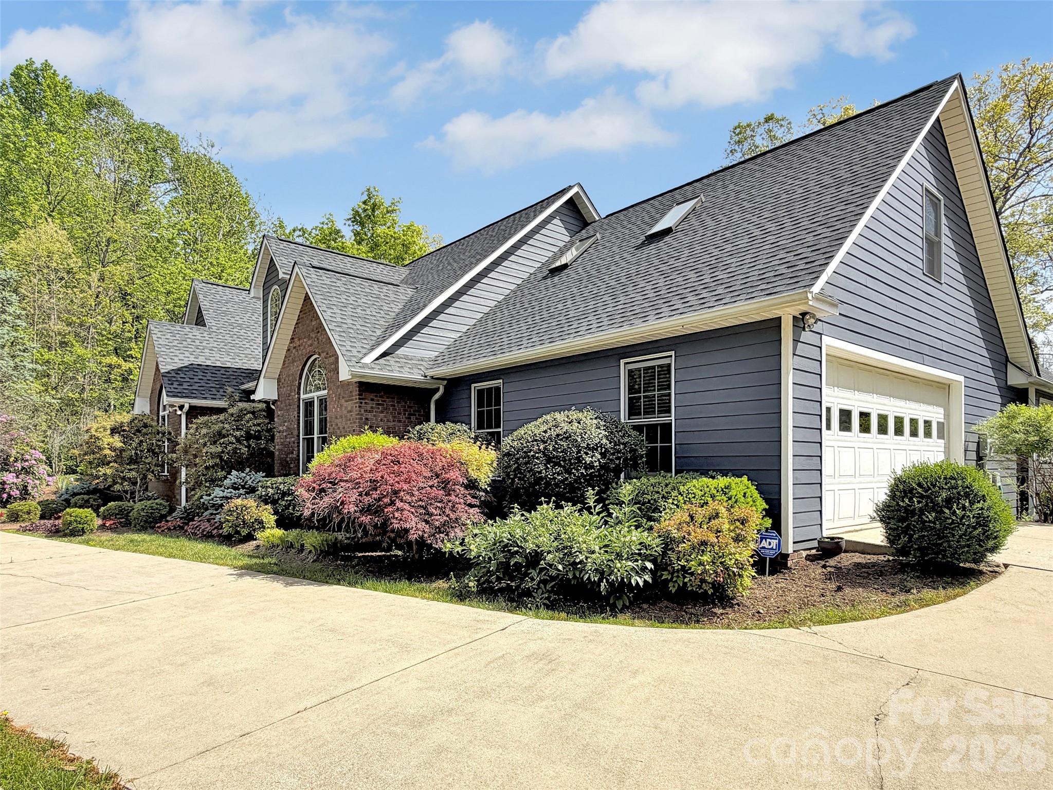 88 Adams Drive Clyde, NC 28721 - Photo 41 of 47 a front view of a house with a yard and garage