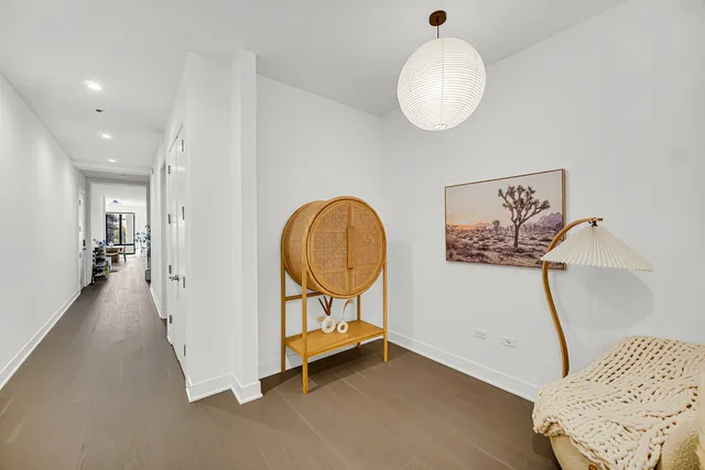 a view of a hallway with entryway wooden floor and front door