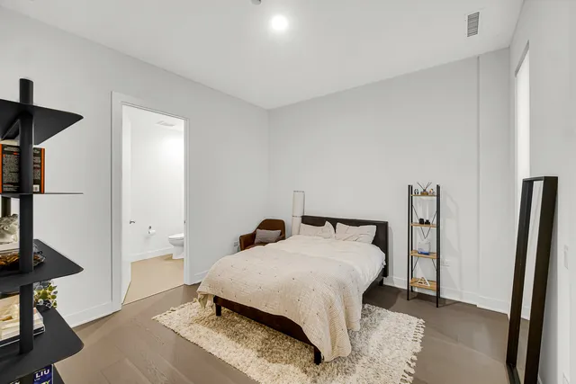 a bedroom with a bed and a mirror