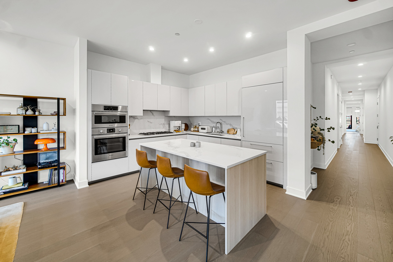 323 South Racine Avenue, Unit 5A Chicago, IL 60607 - Photo 2 of 26 a view of kitchen with stainless steel appliances kitchen island a stove a refrigerator and a dining table with wooden floor