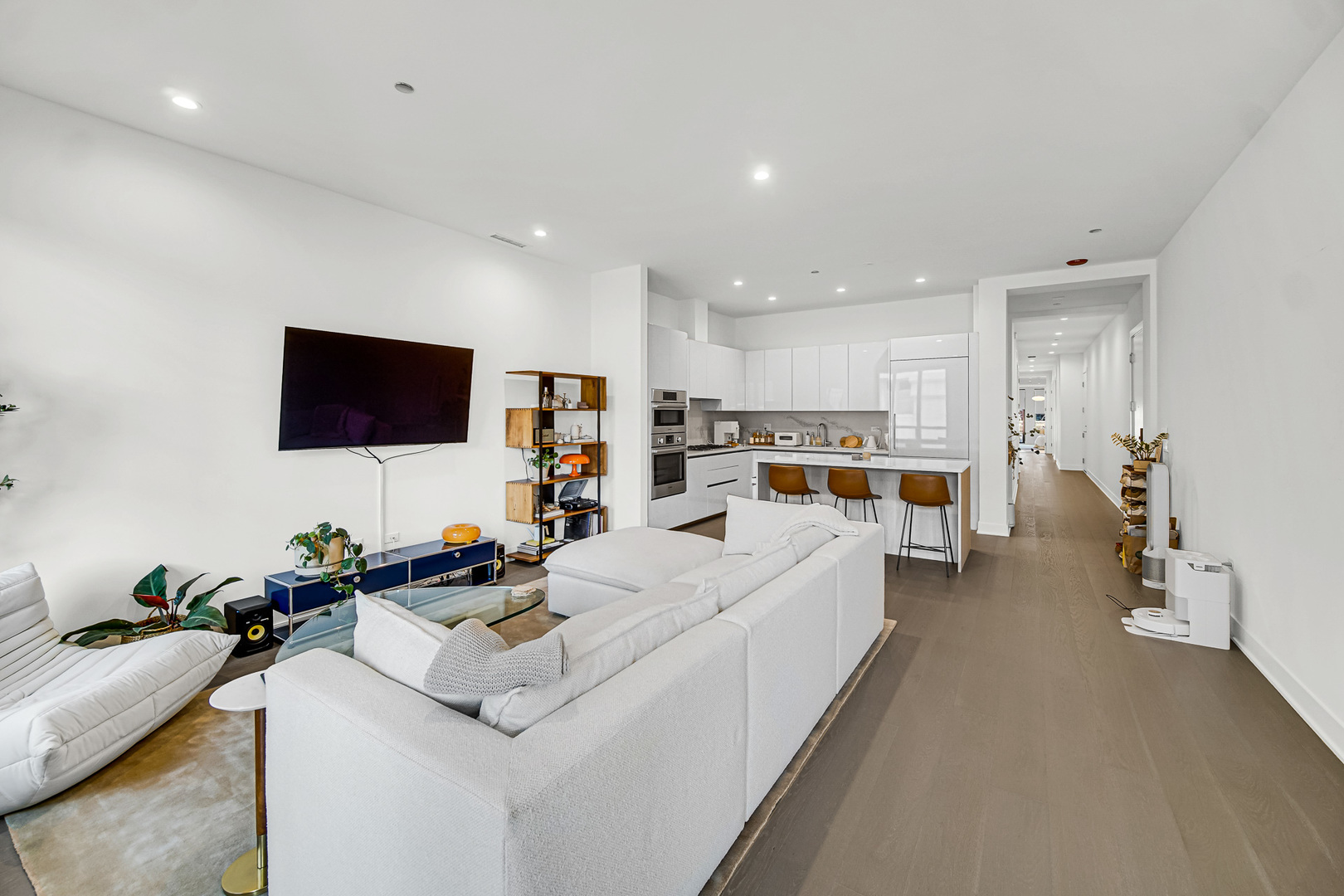 323 South Racine Avenue, Unit 5A Chicago, IL 60607 - Photo 3 of 26 a living room with furniture and a flat screen tv