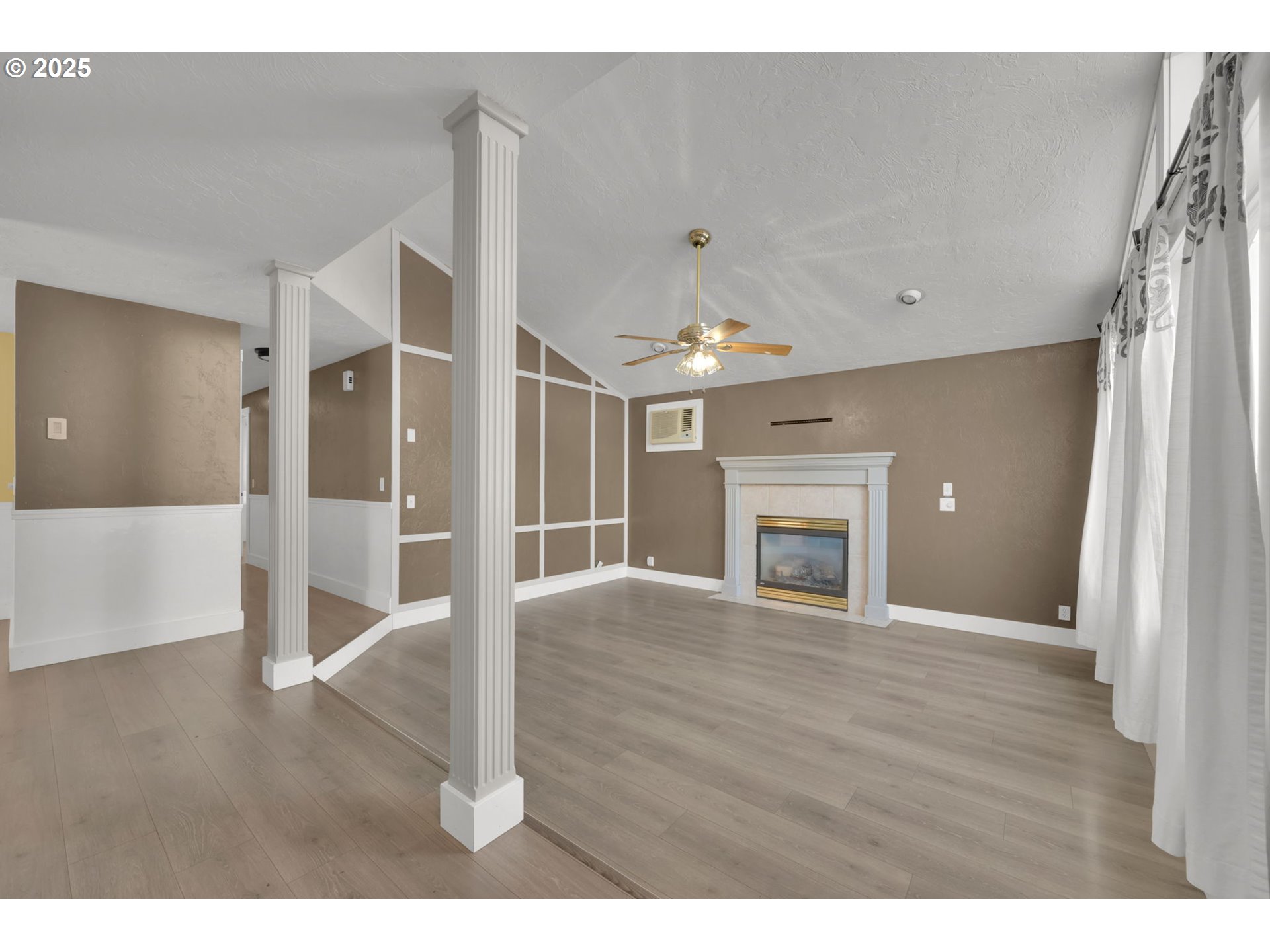 5781 E Street Springfield, OR 97478 - Photo 8 of 36 a view of a livingroom with wooden floor a fireplace and window