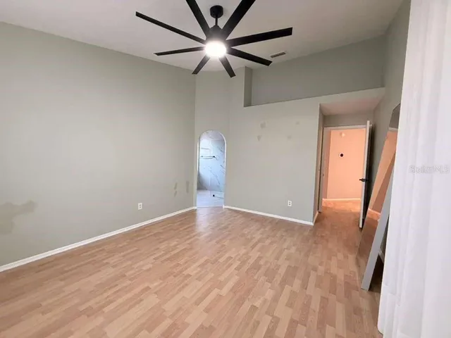 a bathroom with a granite countertop sink a mirror and shower