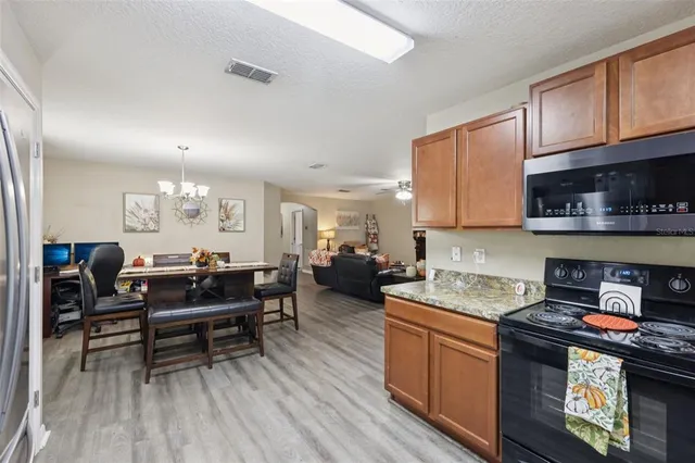 a kitchen with sink cabinets and wooden floor