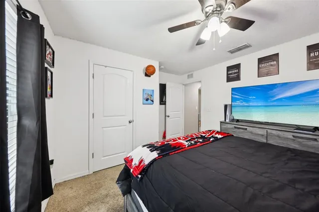 a bedroom with bed and a chandelier