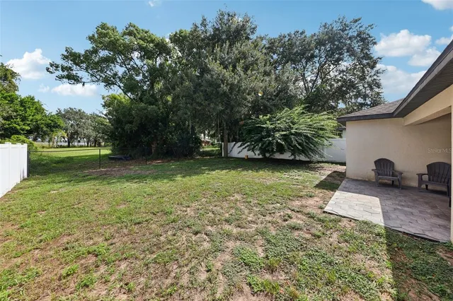 a backyard of a house with lots of green space