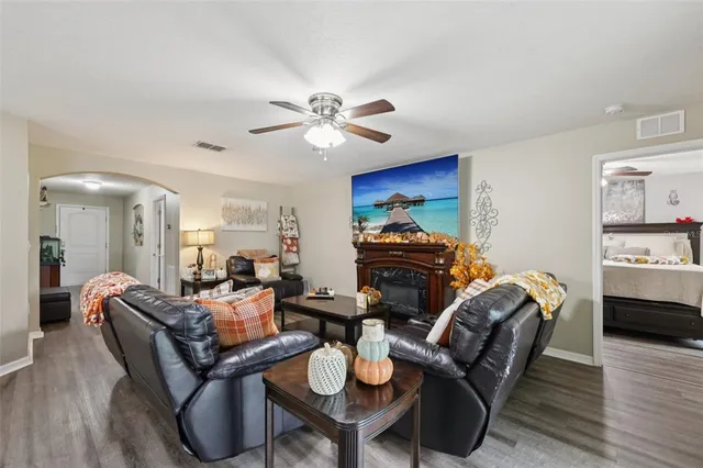 a living room with furniture a couch and wooden floor