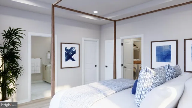 a bedroom with a large bed and a potted plant