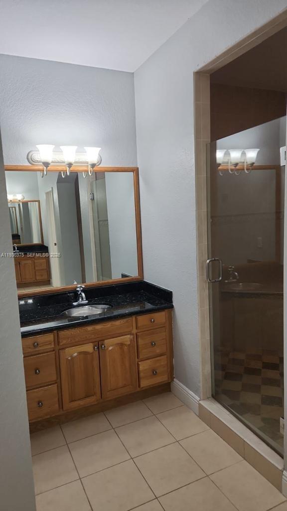 3187 Southwest 143rd Place Miami, FL 33175 - Photo 11 of 22 a view of a double vanity sink and a mirror