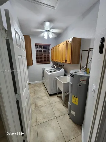 a bathroom with a granite countertop sink a toilet and shower