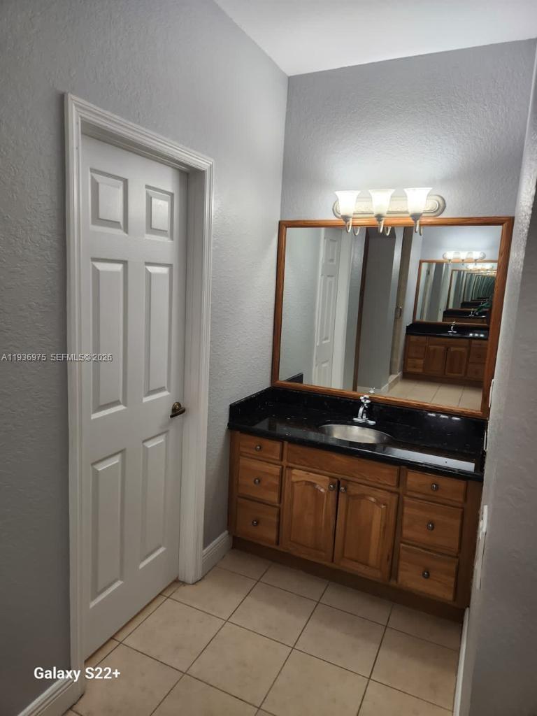 3187 Southwest 143rd Place Miami, FL 33175 - Photo 20 of 22 a bathroom with a sink a mirror and a bathtub