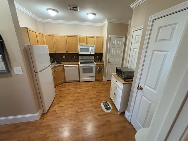 a kitchen with a refrigerator a washer and dryer