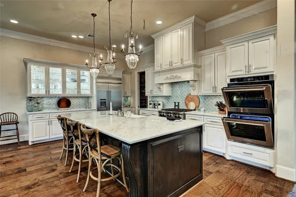 a kitchen with a stove a sink a dining table and chairs