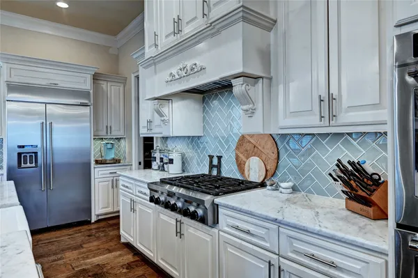 a kitchen with stainless steel appliances granite countertop a stove and a refrigerator