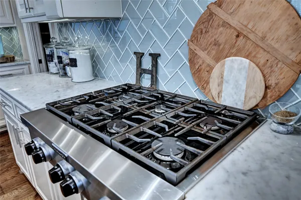 a stove sitting inside of a kitchen next to a stove