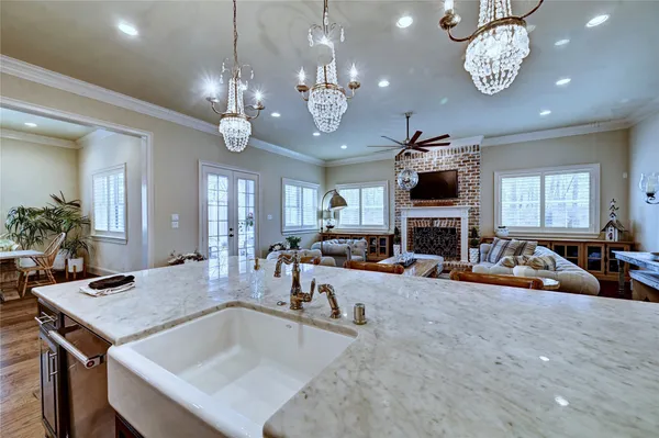a view of a dining room with furniture a chandelier and wooden floor
