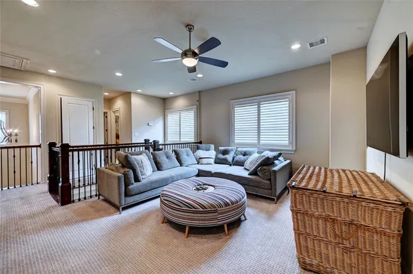 a spacious bedroom with a bed a couch and a flat screen tv