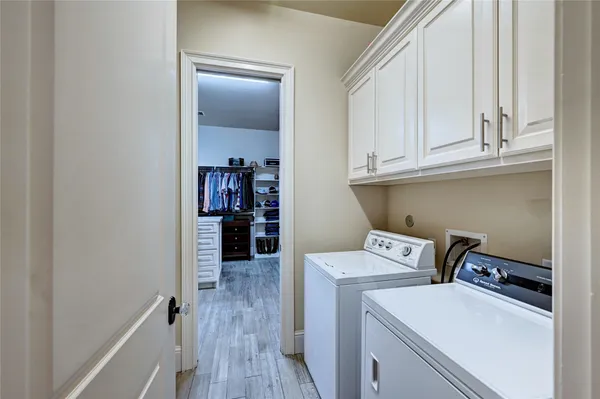 a utility room with dryer washer and empty racks