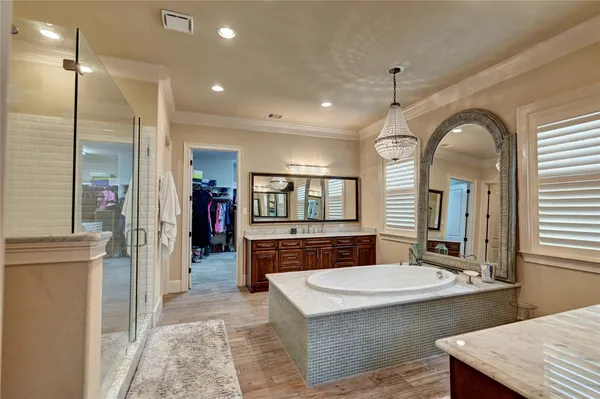 a bathroom with a sink a large mirror and a shower