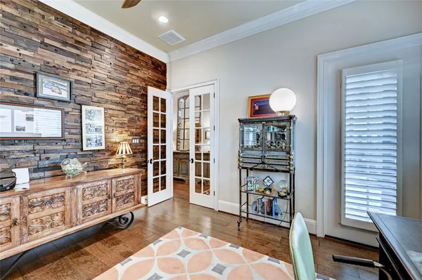 a dining room with wooden floor and furniture