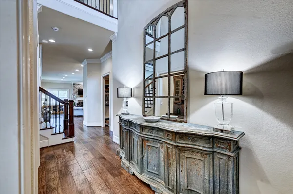 a kitchen with stainless steel appliances granite countertop a sink a stove and a wooden floors
