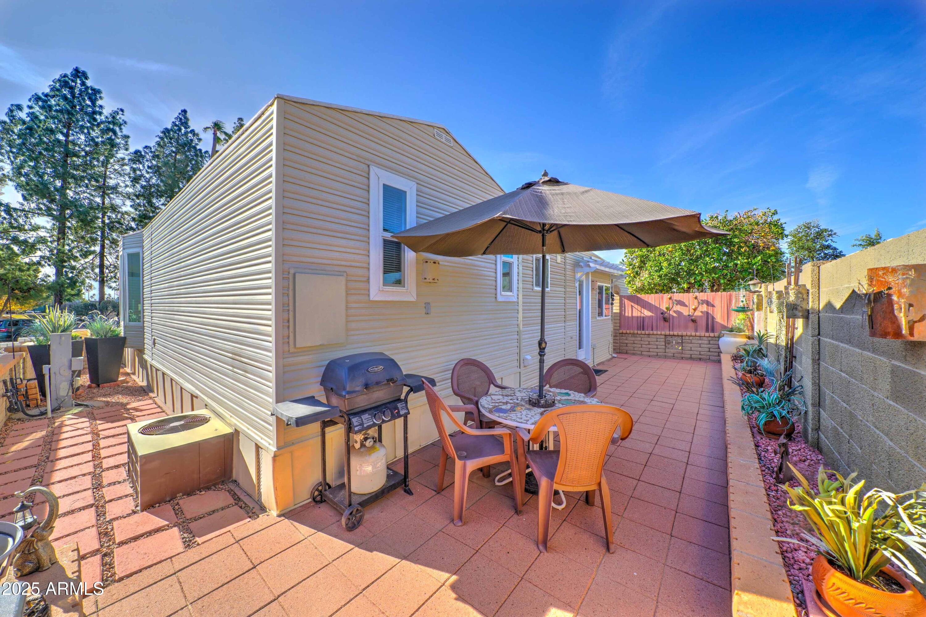 111 South Greenfield Road, Unit 633 Mesa, AZ 85206 - Photo 11 of 32 a view of a table and chairs under an umbrella in patio