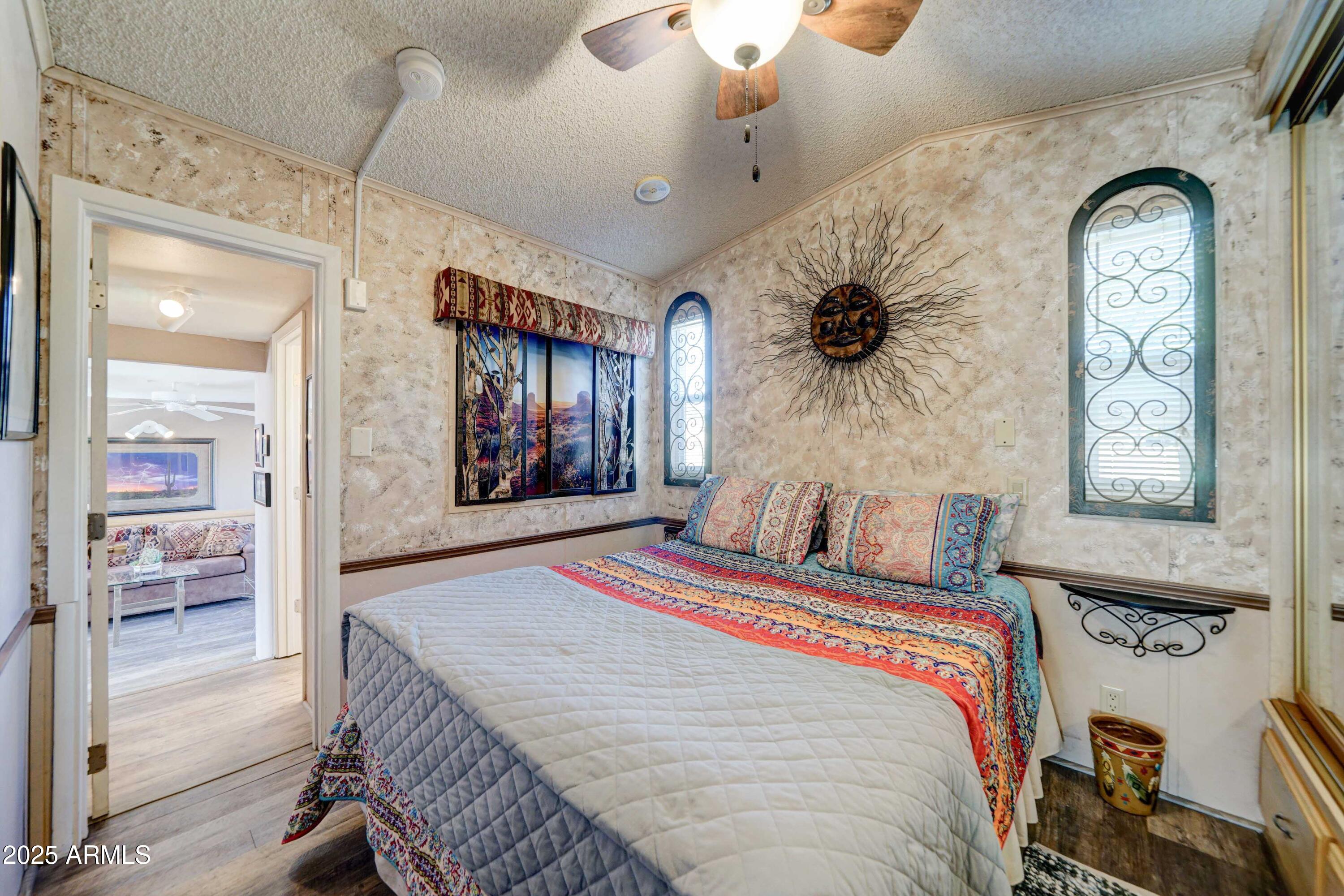 111 South Greenfield Road, Unit 633 Mesa, AZ 85206 - Photo 15 of 32 a bedroom with a bed and a mirror