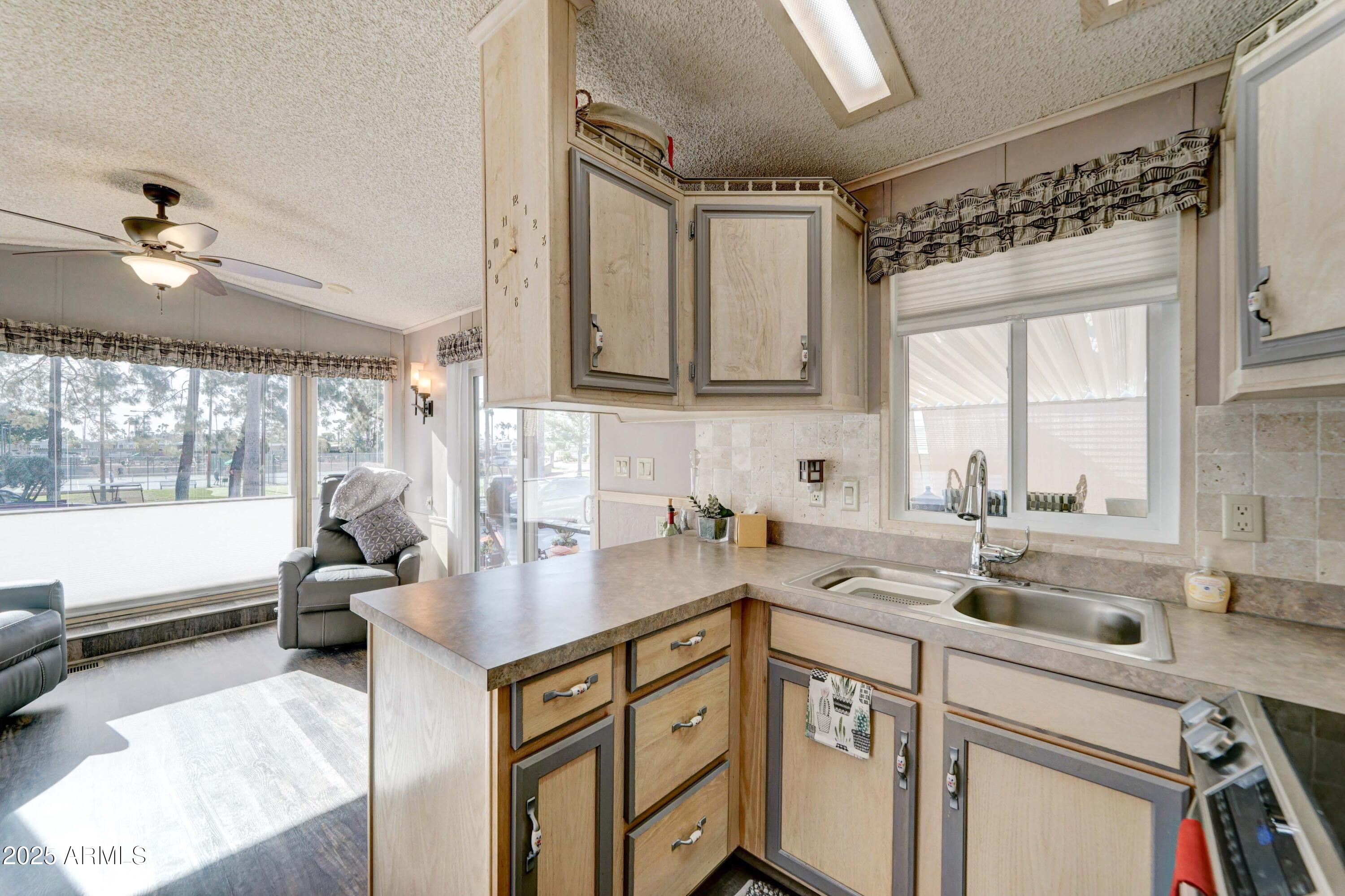 111 South Greenfield Road, Unit 633 Mesa, AZ 85206 - Photo 19 of 32 a kitchen with a sink cabinets appliances and a window
