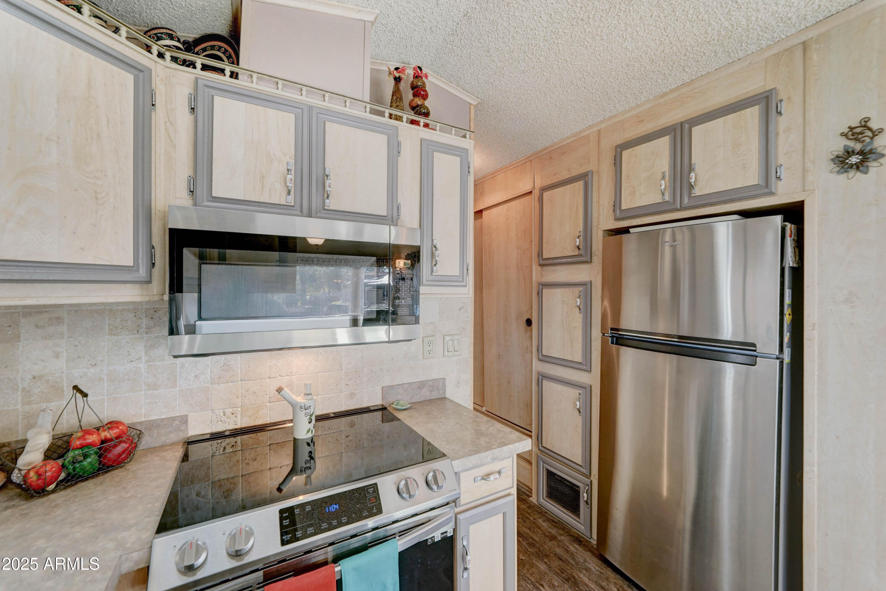 111 South Greenfield Road, Unit 633 Mesa, AZ 85206 - Photo 21 of 32 a kitchen with stainless steel appliances granite countertop a refrigerator sink stove and microwave