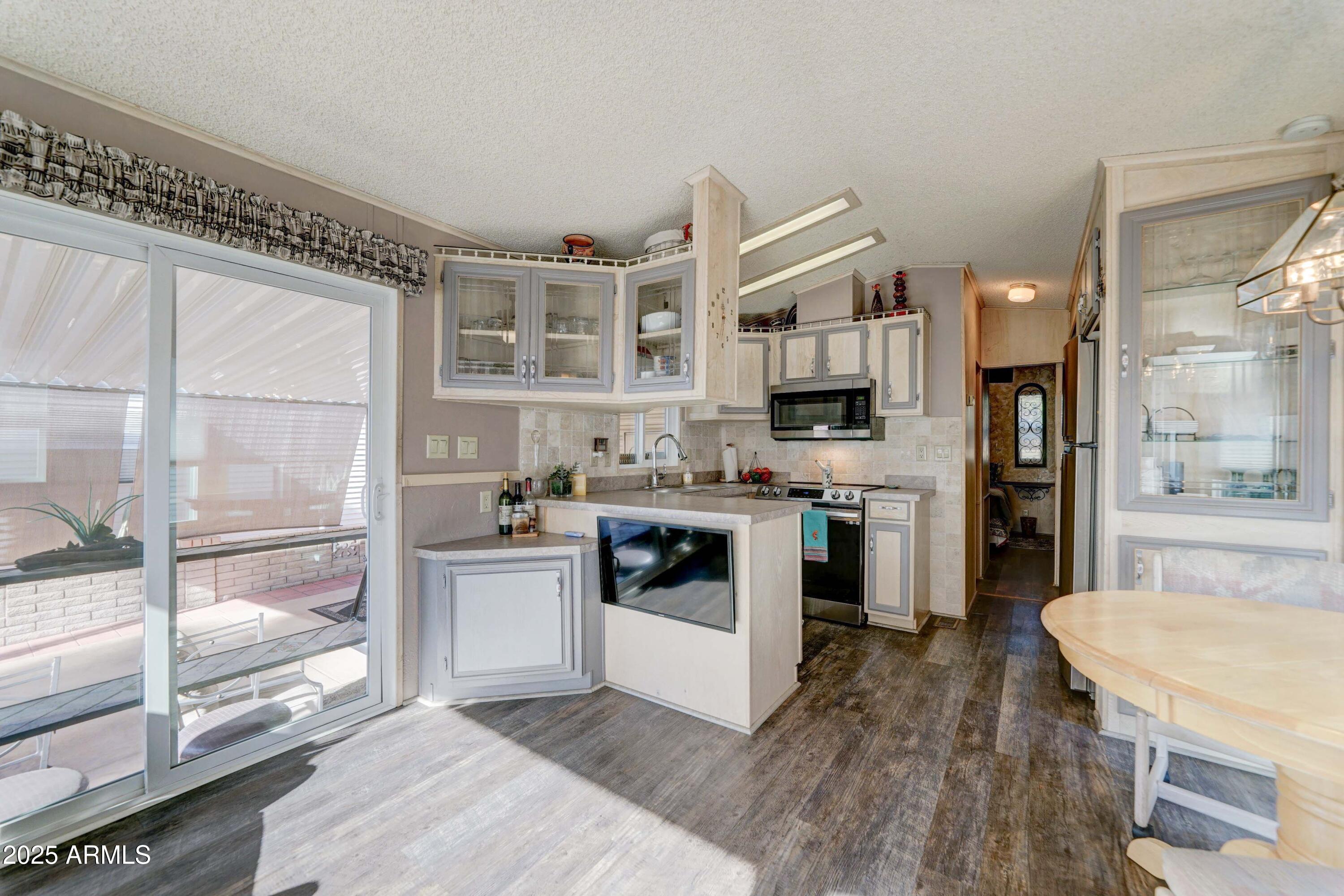 111 South Greenfield Road, Unit 633 Mesa, AZ 85206 - Photo 32 of 32 a kitchen with stainless steel appliances granite countertop a stove a sink and a refrigerator