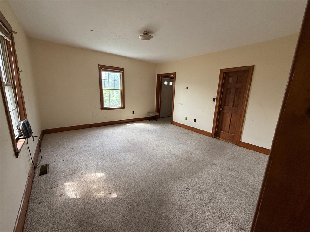 1143 Beacon Street, Unit 1 Newton, MA 02461 - Photo 3 of 4 an empty room with windows