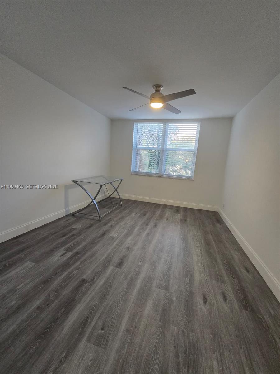 6500 Cypress Road, Unit 301 Plantation, FL 33317 - Photo 11 of 15 an empty room with wooden floor and windows