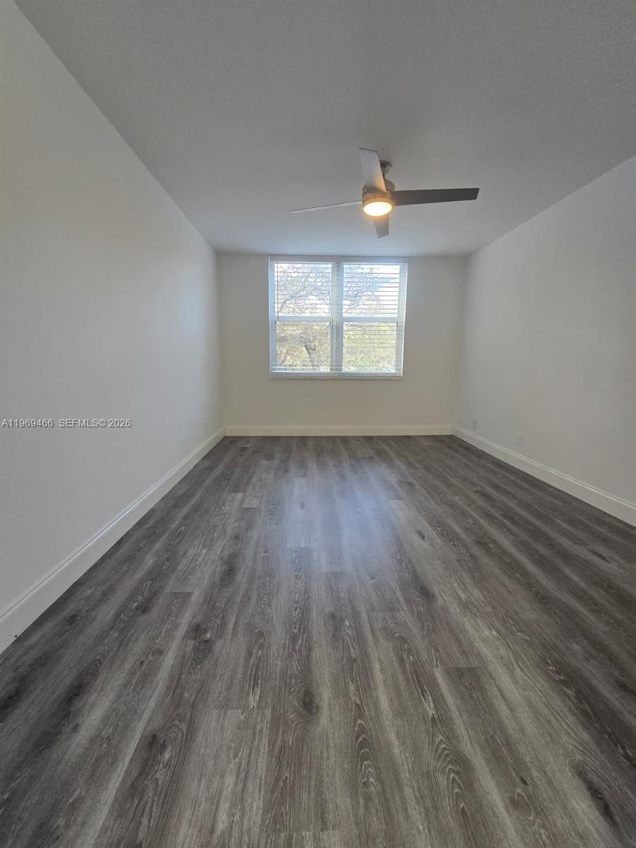 6500 Cypress Road, Unit 301 Plantation, FL 33317 - Photo 13 of 15 wooden floor in an empty room with a window