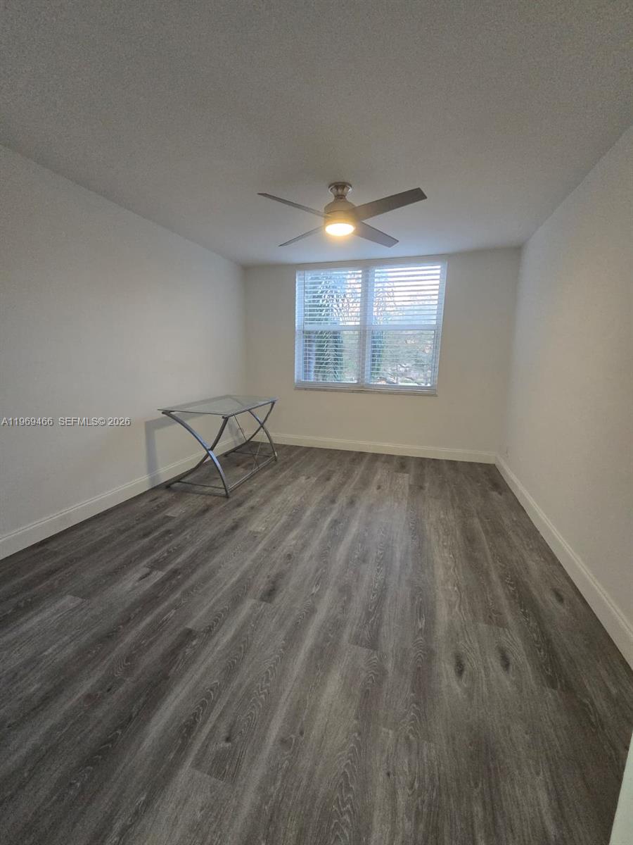 6500 Cypress Road, Unit 301 Plantation, FL 33317 - Photo 14 of 15 an empty room with wooden floor and windows