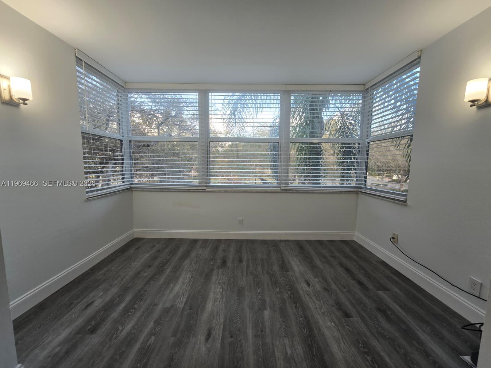 6500 Cypress Road, Unit 301 Plantation, FL 33317 - Photo 5 of 15 a view of an empty room with wooden floor and a window